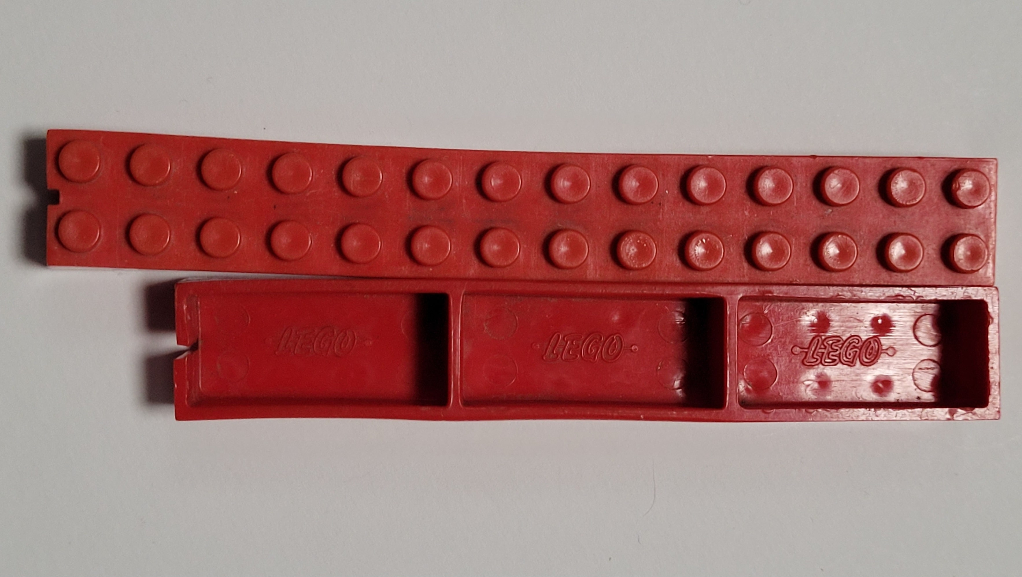 Long red LEGO beams with dogbone logo